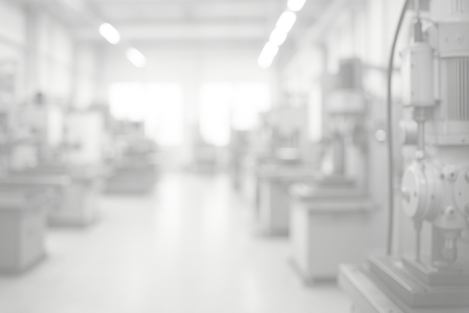 blurred industrial machinery background with soft lighting, white overlay for readability, clean and professional atmosphere, subtle depth of field